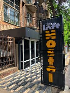 a building with a sign in front of it at The Loft Hostel in Tashkent