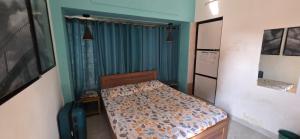 a small bedroom with a bed in a room at Hottel! Basera in Bhubaneshwar