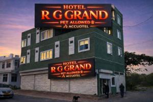 a hotel with neon signs on the side of a building at Accuotel Inn RG Grand in Kanāria