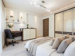 a bedroom with a bed and a desk and a chair at Urban Chic - One Bedroom Apartment -Luxury Warsaw Stays - Grzybowska 5 in Warsaw