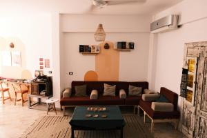 a living room with a couch and a table at Tranquilo Boutique Hostel - Dahab in Dahab