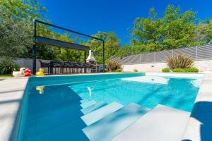 a swimming pool in the backyard of a house at Modern Villa with Pool and Wellness in Sveti Vid-Miholjice