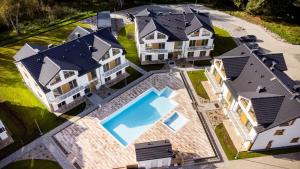 an aerial view of a house with a swimming pool at Wydmowa Ostoja in Żarnowska
