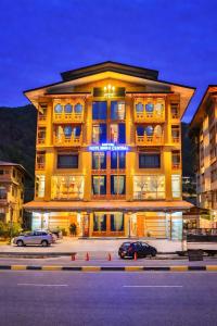 ein Gebäude, vor dem Autos parken in der Unterkunft Hotel HTC , Thimphu in Thimphu
