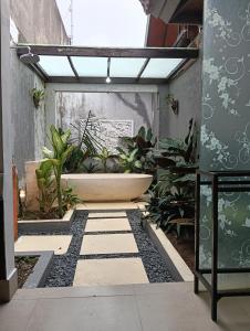 a bathroom with a bath tub and plants in it at Sri Abi Ratu Villa in Sukawati