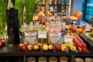a display of fruit and drinks in buckets on a table at Q Hotel Plus Wrocław in Wrocław