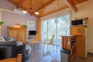 a living room with a couch and a table at Gite Du Mouredon in Vallon-Pont-dʼArc