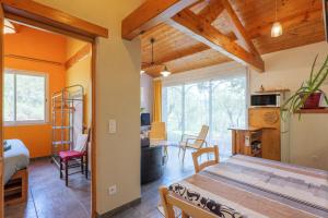 a room with a bed and a dining room at Gite Du Mouredon in Vallon-Pont-dʼArc