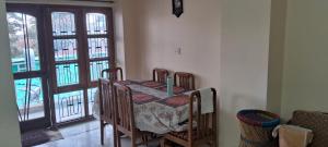 a dining room with a table with a candle on it at Sewa Kunj in Mussoorie