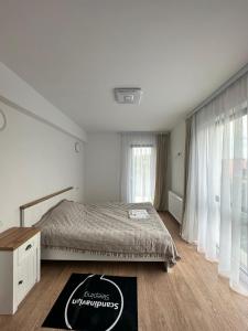a bedroom with a bed and a large window at Hotel Class in Oradea +35 photos