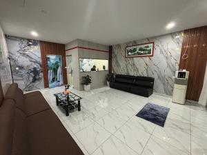 a living room with a couch and a table at Collection O Near Sunway Karnival Mall Formerly Rest Haven in Bukit Mertajam