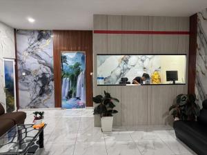a lobby with a reception desk and paintings on the wall at Collection O Near Sunway Karnival Mall Formerly Rest Haven in Bukit Mertajam