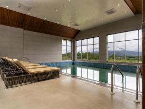 a swimming pool with a spa tub in a building at Mountnoor Sarovar Premiere Pahalgam in Anantnāg