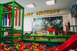 a play room with a playground with balls and a slide at LOFT Home in Daugavpils +7 photos