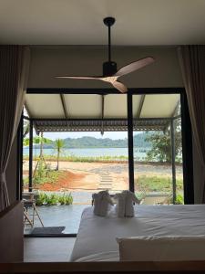 a bedroom with a bed with a view of a beach at Wave & Vibes Koh chang in Ban Chek Bae (1)