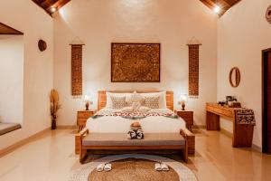 a bedroom with a large bed and a table at Bagus Bandem Villa in Ubud +82 photos