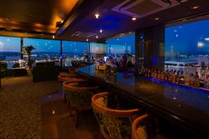 a bar with a view of a city at night at Premier Hotel -CABIN- Asahikawa in Asahikawa