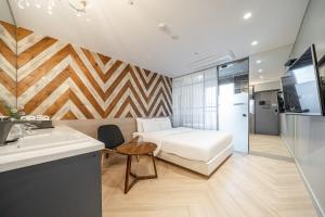 a bedroom with a bed and a sink and a bathroom at Hotel Lassa in Seoul