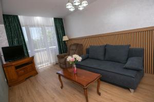 a living room with a couch and a coffee table at Hotel Senator in Slatina