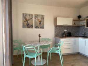 a kitchen with a table and chairs in a room at Apartmány MAX - Jeseníky in Vaclavov u Bruntalu