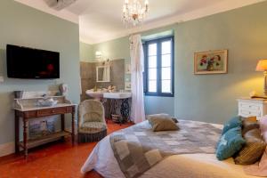 a bedroom with a bed and a bathroom with a sink at Maison D'hôtes Casa Ghjunca in Rapale +99 photos
