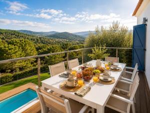 a table with food and drinks on a balcony with a view at VILLA PARADISE SILVIA in Sant Pere de Ribes