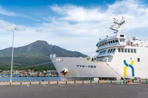a large cruise ship is docked in the water at Shimano Yado Rishirikuru in Rishiri