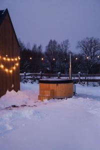 a wooden building in the snow with lights on it at Zen Sasino in Sasino +75 photos