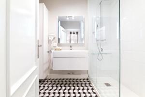 a white bathroom with a sink and a shower at Apartamento Platas Centro in Ribadesella +11 photos