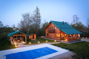 a log cabin with a pool and a gazebo at Lika View house in Gospić