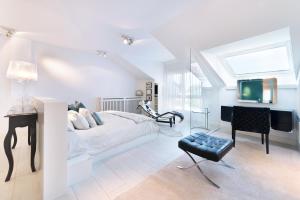 a bedroom with a bed and a desk and a television at Apartamento Platas Centro in Ribadesella