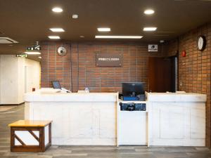 an office with two counters and a desk with a computer at Itoen Hotel Hakone Yumoto in Hakone +23 photos