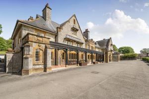 an old stone building with a lot of windows at Harcombe House Rooms - First Floor Twin in Newton Abbot