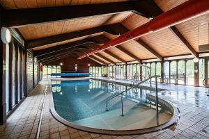 a large swimming pool in a building at Harcombe House Rooms - First Floor Twin in Newton Abbot