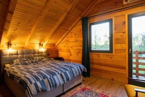 a bedroom with a bed in a log cabin at Lika View house in Gospić +49 photos