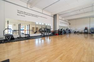 an empty gym with a wooden floor and gym equipment at Harcombe House Rooms - First Floor Double in Newton Abbot