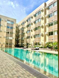 a large apartment building with a large swimming pool at Atelier Studio, Stanford Suites 3, Silang in Silang