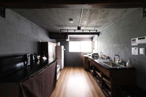 a kitchen with a counter and a sink and a refrigerator at Entire Traditional House, Pet Friendly,貸切古民家,最大9名,ペット可, 長野岡谷IC5分,ファミリー歓迎 in Okaya