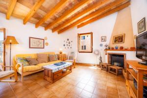 a living room with a couch and a fireplace at Ca Sa Padrina Banyalbufar in Banyalbufar