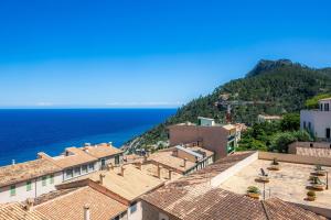 a view of roofs of a town and the ocean at Ca Sa Padrina Banyalbufar in Banyalbufar
