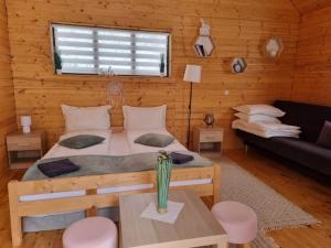 a bedroom with a bed and a couch in a room at Chill Glamping in Corbu