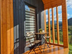 a patio with a table and chairs on a house at Chill Glamping in Corbu +6 photos