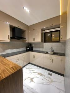 a kitchen with white cabinets and a sink at Sky square murree in Murree +152 photos