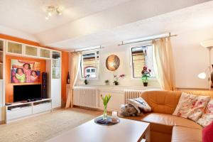 a living room with a couch and a tv at Über den Dächern in Cochem Altstadt in Cochem