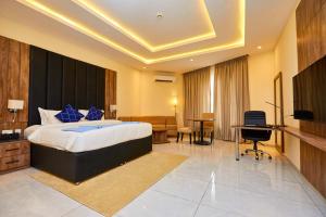 a hotel room with a bed and a television at Vintano Hotel in Lagos