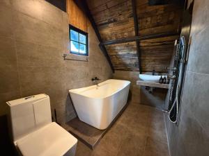 a bathroom with a white tub and a sink at Eden Heaven Villa in Nuwara Eliya +46 photos