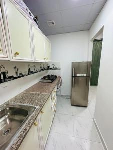 a kitchen with a sink and a refrigerator at 16 Villa in Sabkhah +16 photos