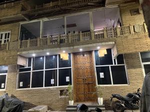 a building with a wooden door and a balcony at Staylo Suites Edit in New Delhi