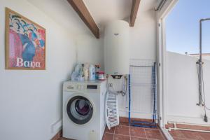 a bathroom with a washing machine in a room at Villa Sol del Este, Es Castell in Es Castell