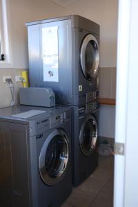three washing machines and a washer and dryer in a room at Cobar Central Motor Inn in Cobar